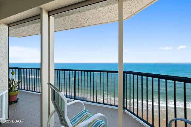 unfurnished sunroom with a water view and a view of the beach