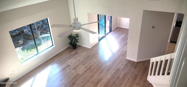 unfurnished bedroom with ceiling fan, connected bathroom, and light hardwood / wood-style floors