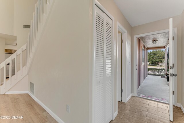 hall featuring light tile patterned floors