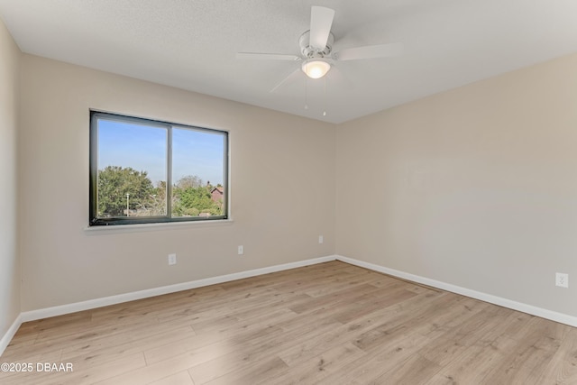 unfurnished room with ceiling fan and light wood-type flooring