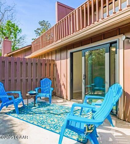 view of patio featuring fence