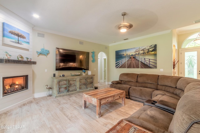 living room with ceiling fan, light hardwood / wood-style flooring, and crown molding