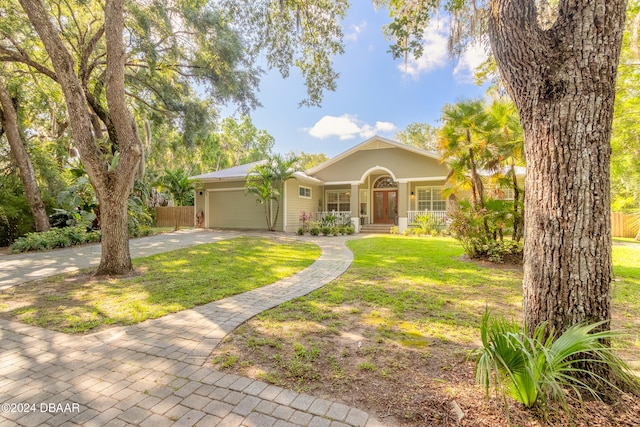 ranch-style house featuring a garage and a front yard