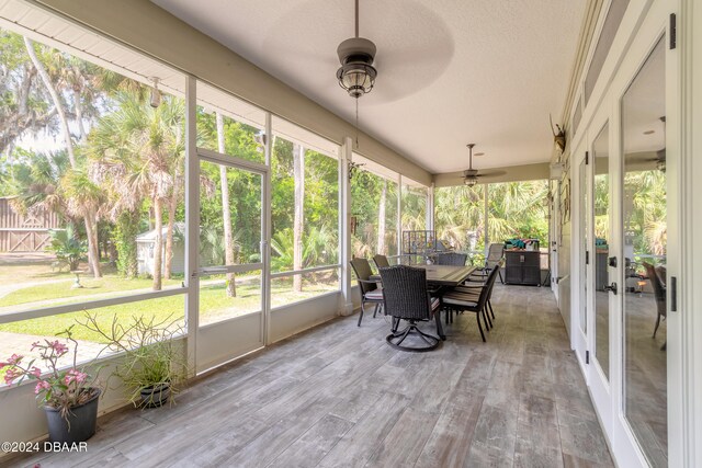 sunroom / solarium with a wealth of natural light and ceiling fan