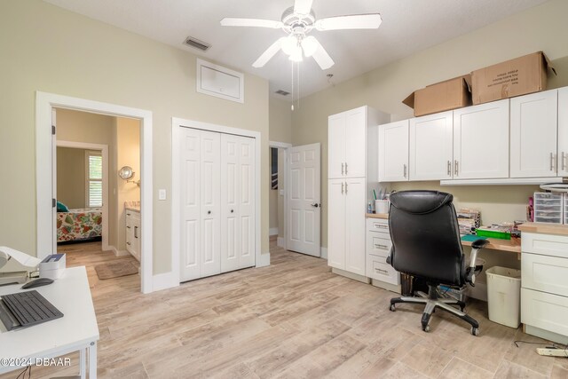 office with light hardwood / wood-style floors and ceiling fan