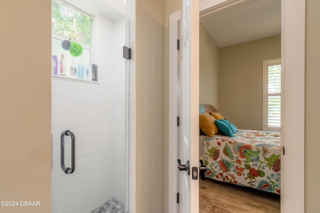 bathroom featuring hardwood / wood-style floors and a shower with shower door