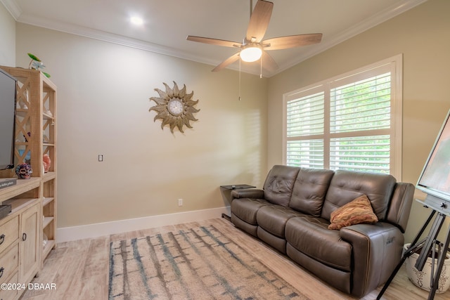 living room featuring light wood-type flooring, ceiling fan, and crown molding