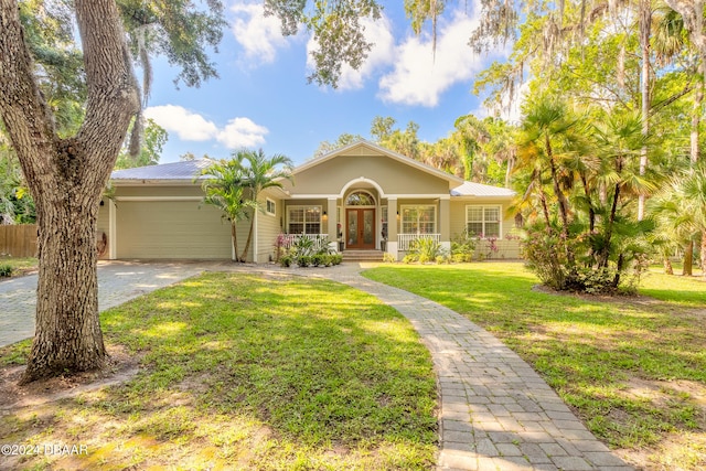 view of front of home with a garage and a front yard