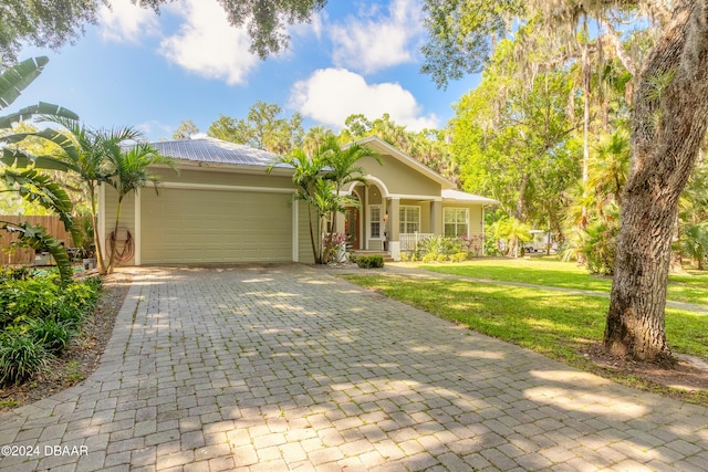 single story home with a garage and a front yard