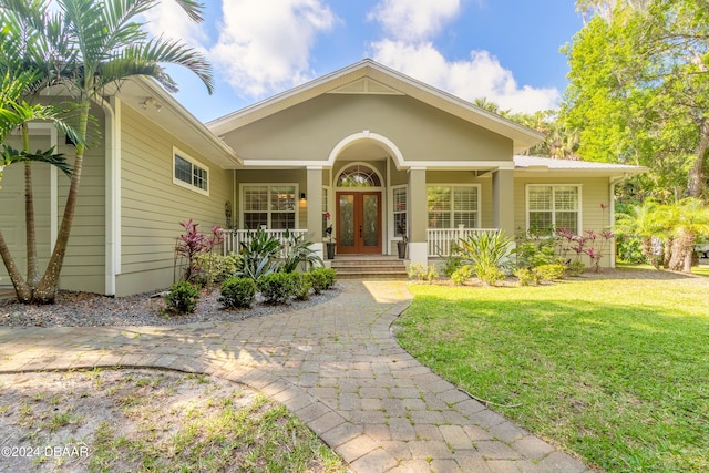 view of front of home featuring covered porch and a front lawn