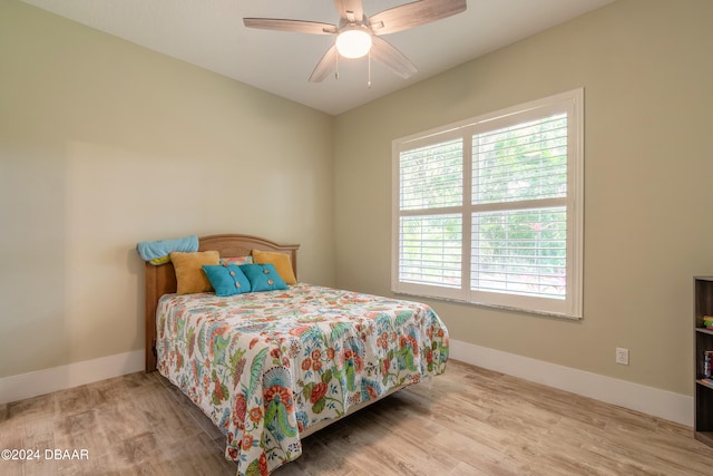 bedroom with light hardwood / wood-style floors and ceiling fan