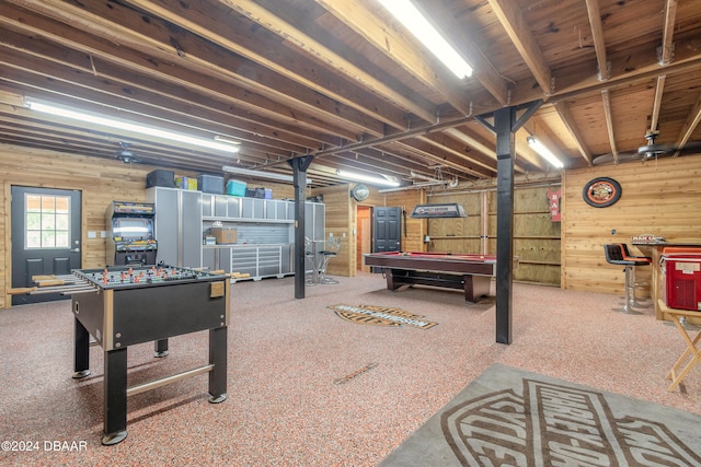 recreation room with wood walls and billiards