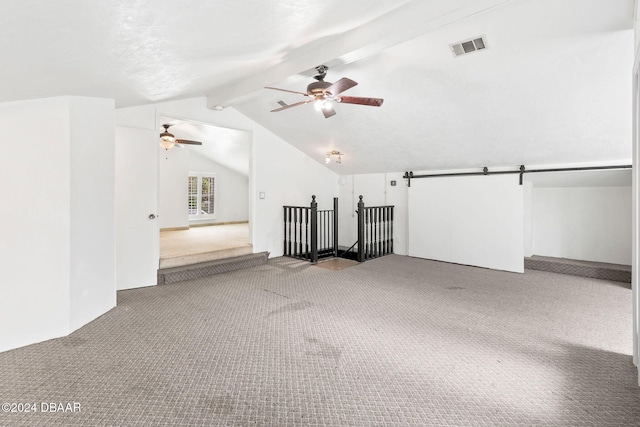 carpeted empty room with lofted ceiling with beams and ceiling fan