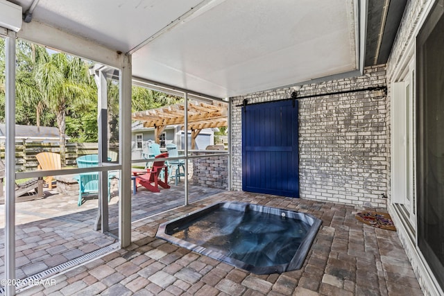 sunroom with a barn door and a jacuzzi