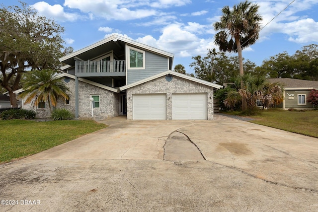 view of front property with a front yard, a balcony, and a garage