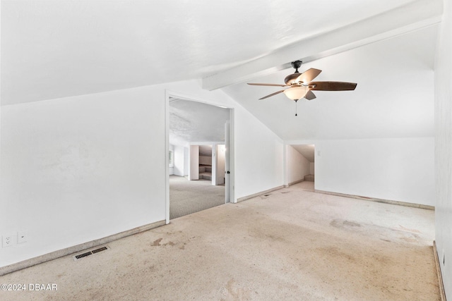 additional living space with vaulted ceiling with beams, ceiling fan, and light carpet