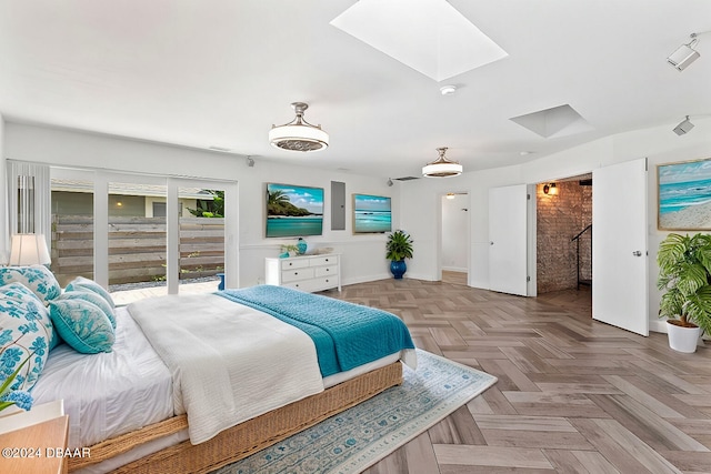 bedroom with light parquet flooring and a skylight