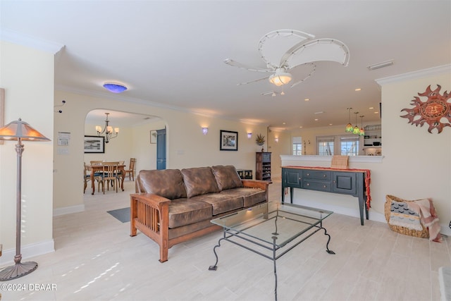 living room with ceiling fan and ornamental molding