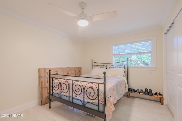 1949 Bayview Dr, New Smyrna Beach, FL 32168 - bedroom with crown molding, baseboards, a closet, and a ceiling fan