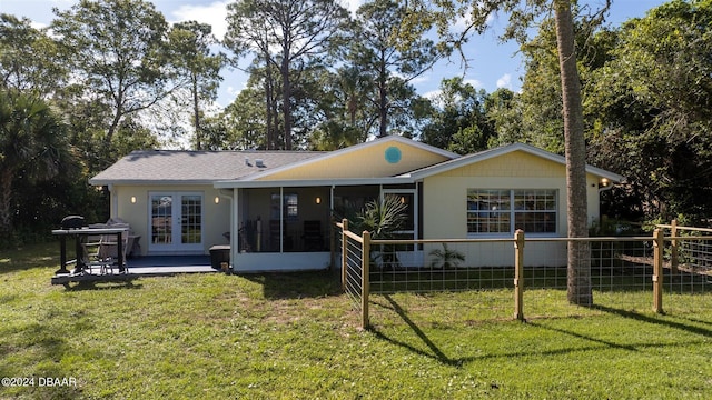 1949 Bayview Dr, New Smyrna Beach, FL 32168 - back of house featuring a sunroom, french doors, and a patio