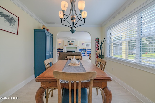 dining area with light hardwood / wood-style flooring, ceiling fan with notable chandelier, and ornamental molding