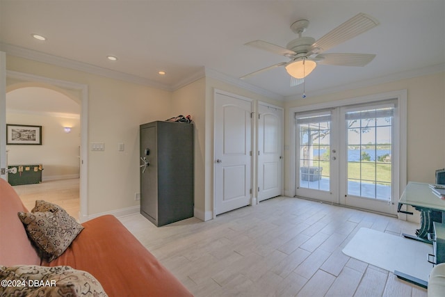 1949 Bayview Dr, New Smyrna Beach, FL 32168 - home office featuring arched walkways, french doors, ornamental molding, light wood finished floors, and ceiling fan