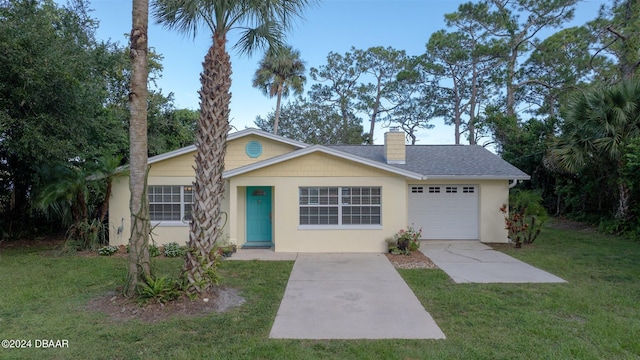 ranch-style house with a garage and a front lawn