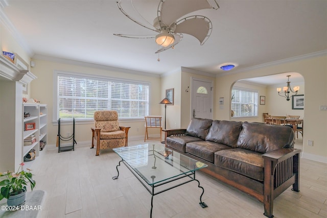 1949 Bayview Dr, New Smyrna Beach, FL 32168 - living area with a chandelier, ornamental molding, arched walkways, a ceiling fan, and light wood finished floors