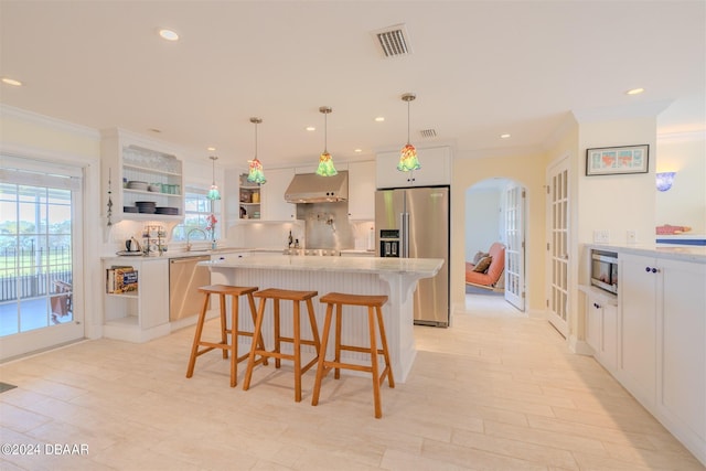 1949 Bayview Dr, New Smyrna Beach, FL 32168 - kitchen with stainless steel appliances, open shelves, ornamental molding, light countertops, and arched walkways