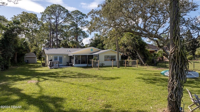 view of yard featuring a storage unit and a sunroom