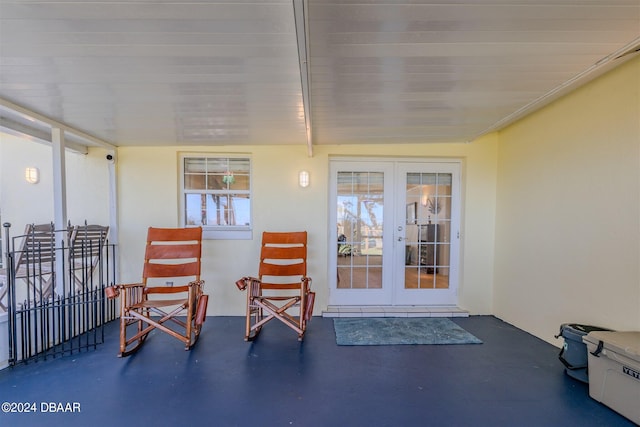 sunroom / solarium featuring french doors