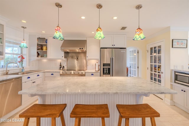 1949 Bayview Dr, New Smyrna Beach, FL 32168 - kitchen with stainless steel appliances, extractor fan, a sink, white cabinetry, and recessed lighting