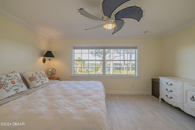 1949 Bayview Dr, New Smyrna Beach, FL 32168 - bedroom featuring multiple windows, ornamental molding, baseboards, light wood finished floors, and a ceiling fan