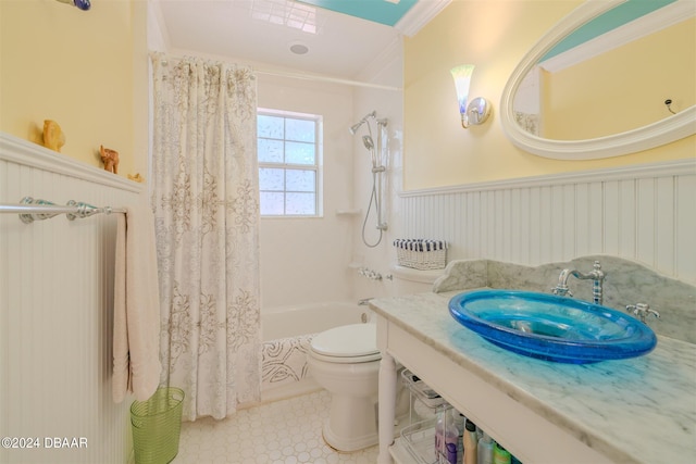 1949 Bayview Dr, New Smyrna Beach, FL 32168 - full bath with wainscoting, toilet, shower / tub combo with curtain, ornamental molding, and vanity