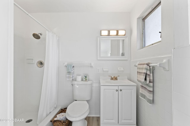 bathroom featuring walk in shower, wood-type flooring, toilet, vanity, and tile walls