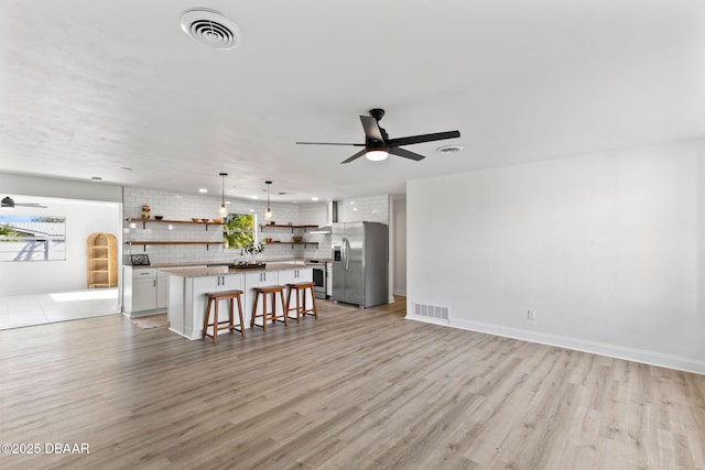 living room featuring light hardwood / wood-style floors and ceiling fan