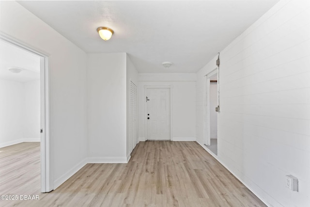 corridor with light hardwood / wood-style floors