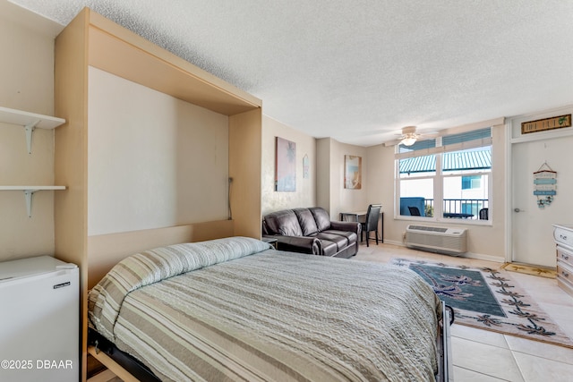 tiled bedroom featuring a textured ceiling, a wall mounted air conditioner, and fridge