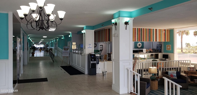 kitchen with white cabinets, a textured ceiling, tile patterned floors, and a notable chandelier