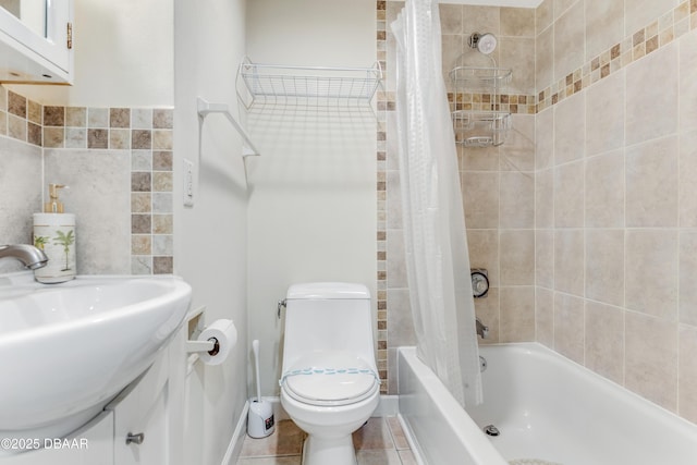 full bathroom with tile patterned floors, sink, shower / bathtub combination with curtain, and toilet