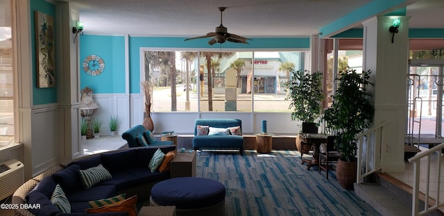 sunroom / solarium featuring ceiling fan