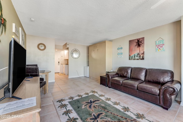 living room with light tile patterned floors and a textured ceiling