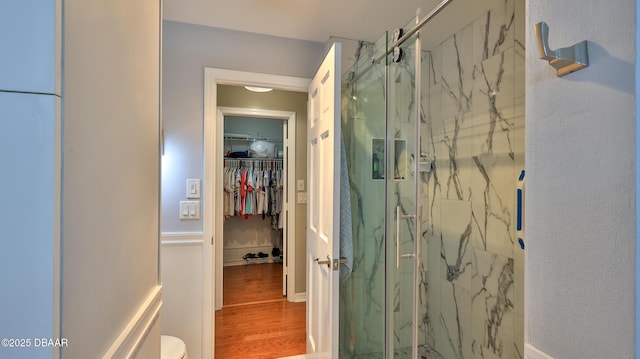 2942 Sea Oats Cir, Daytona Beach, FL 32118 - bathroom featuring a spacious closet, a marble finish shower, and wood finished floors