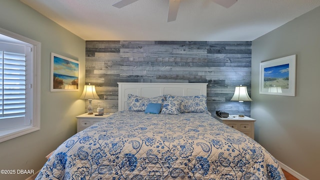 2942 Sea Oats Cir, Daytona Beach, FL 32118 - bedroom with wooden walls, an accent wall, baseboards, and a ceiling fan