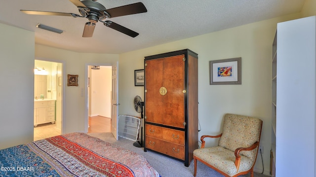 2942 Sea Oats Cir, Daytona Beach, FL 32118 - bedroom with ensuite bathroom, a textured ceiling, light colored carpet, a ceiling fan, and visible vents