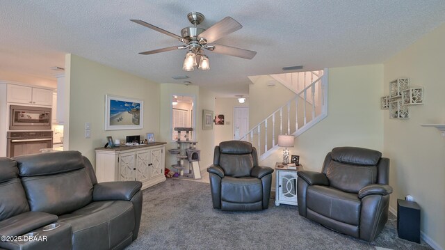 2942 Sea Oats Cir, Daytona Beach, FL 32118 - carpeted living room featuring stairway, visible vents, a textured ceiling, and a ceiling fan