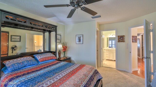 2942 Sea Oats Cir, Daytona Beach, FL 32118 - carpeted bedroom featuring visible vents, baseboards, ceiling fan, a textured ceiling, and ensuite bath