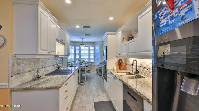 2942 Sea Oats Cir, Daytona Beach, FL 32118 - kitchen featuring fridge, open shelves, white cabinetry, a sink, and black electric cooktop