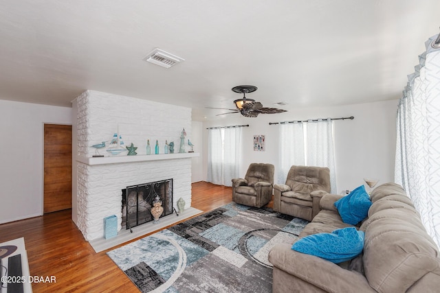59 Arroyo Pkwy, Ormond Beach, FL 32174 - living area featuring wood finished floors, ceiling fan, and a large fireplace