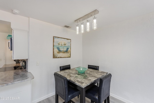 59 Arroyo Pkwy, Ormond Beach, FL 32174 - dining space featuring baseboards and light wood-style floors